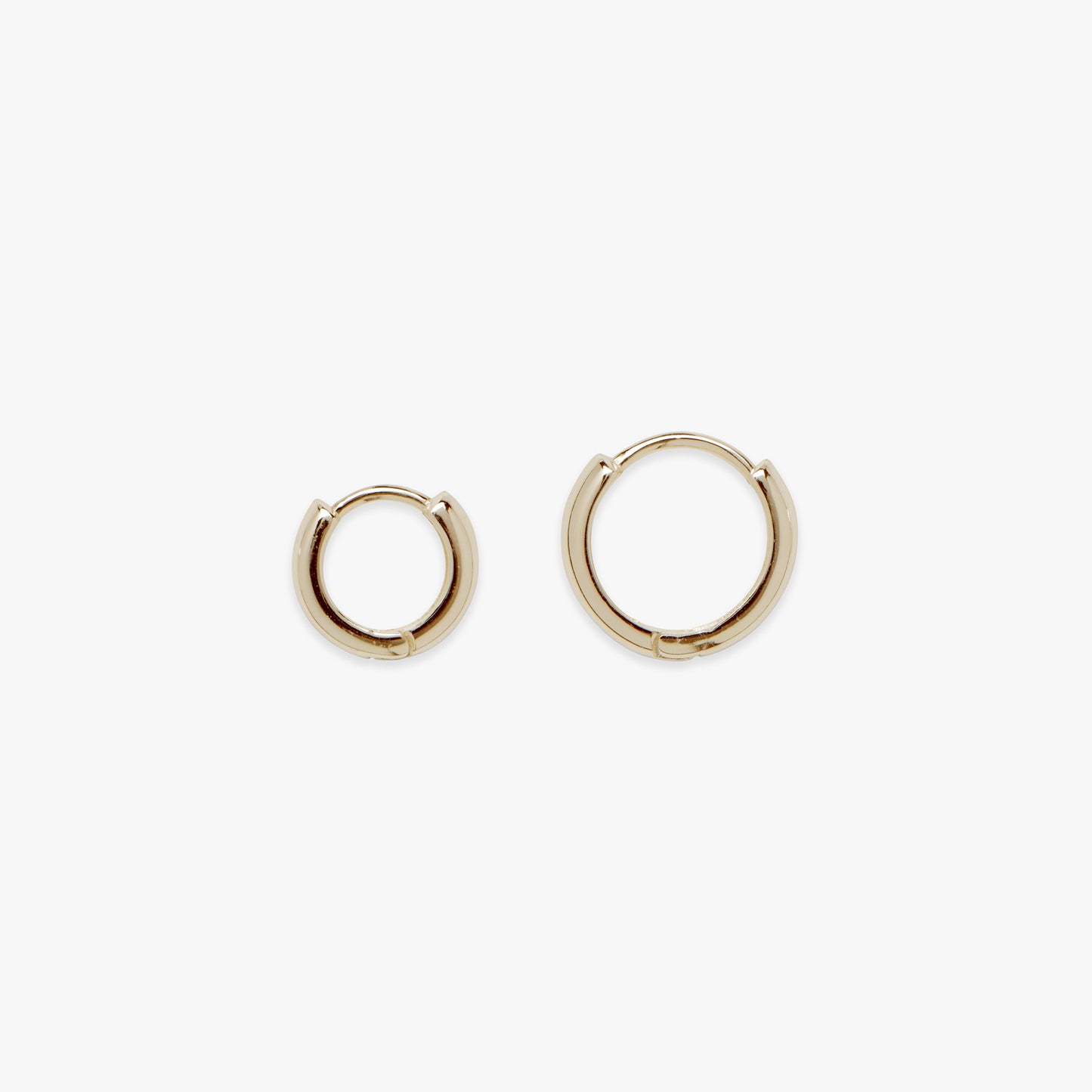 Gold hoop earrings on a white background
