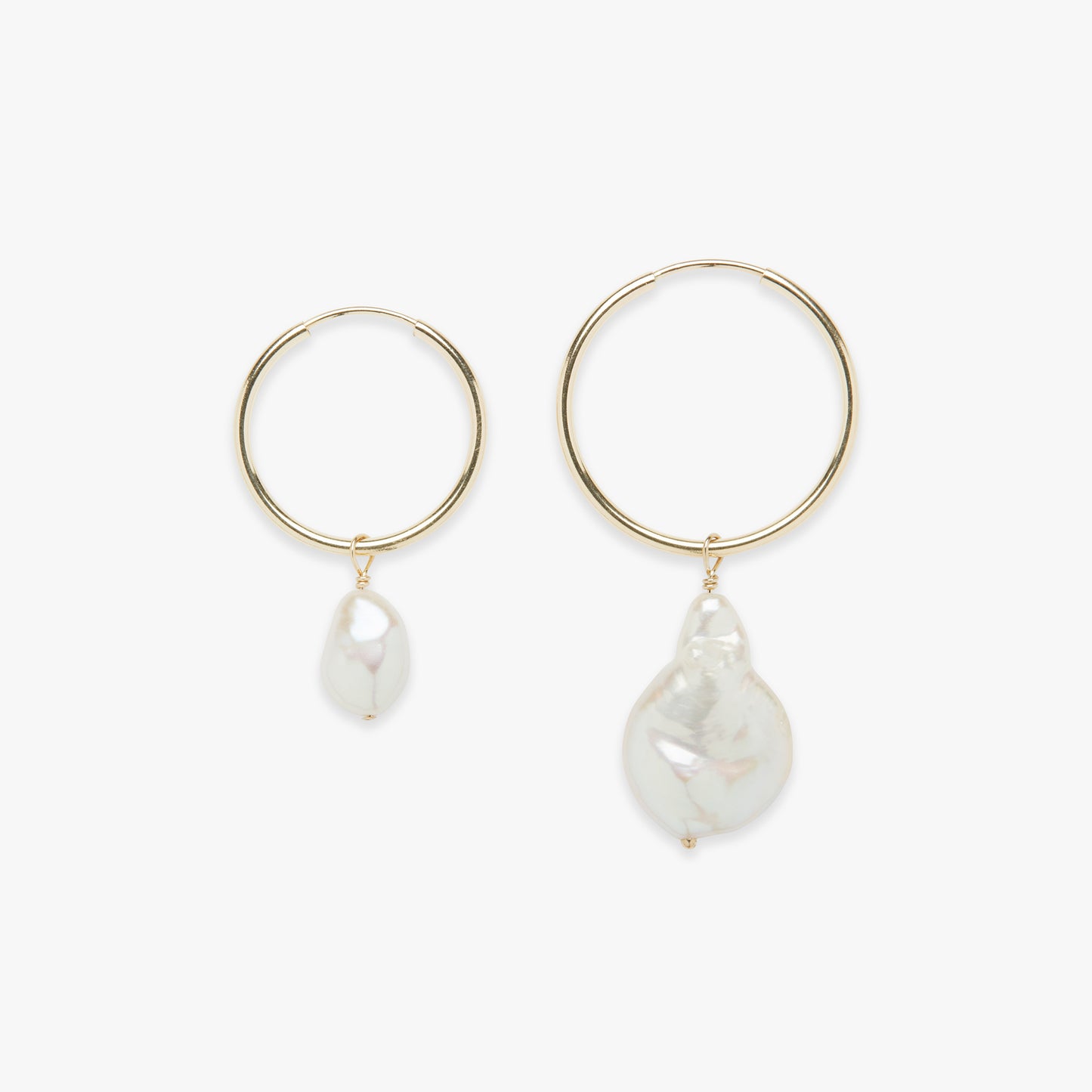 A pair of baroque pearl charm earrings with gold filled hoops.