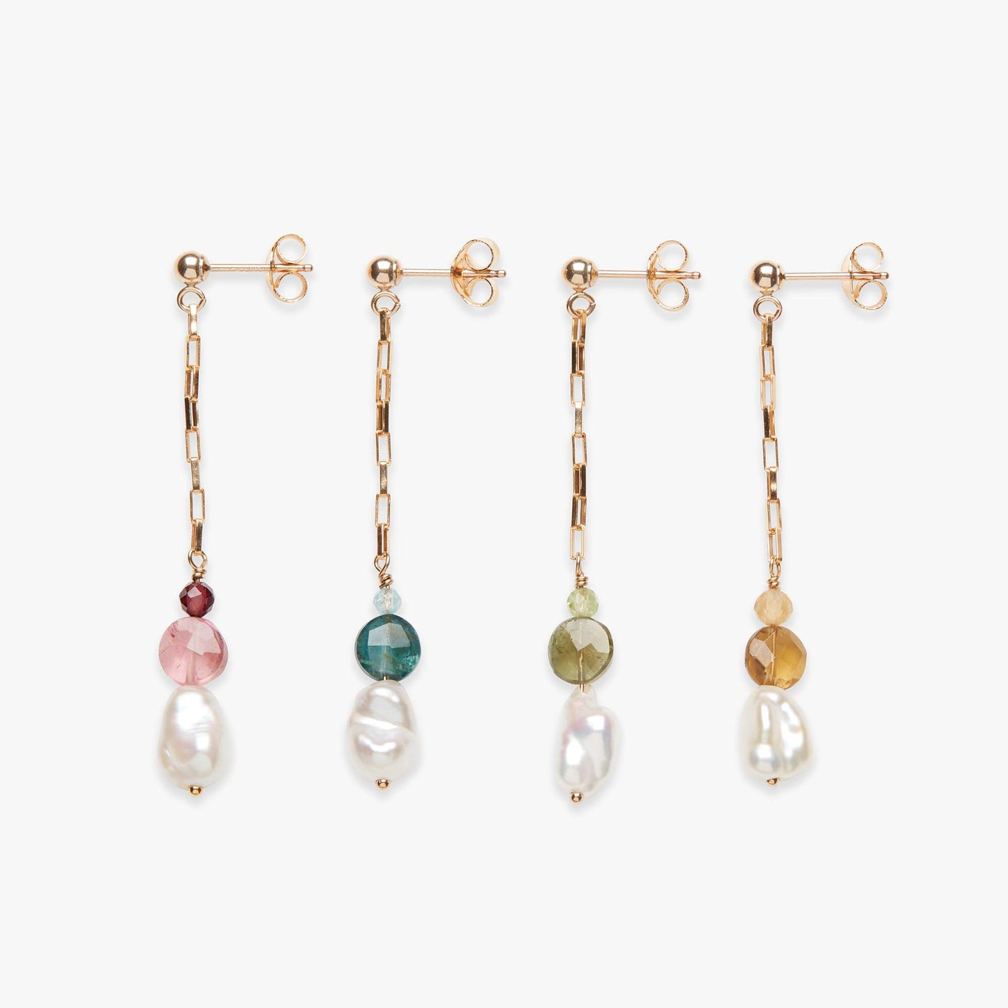 Set of four earrings with various gemstones on a white background