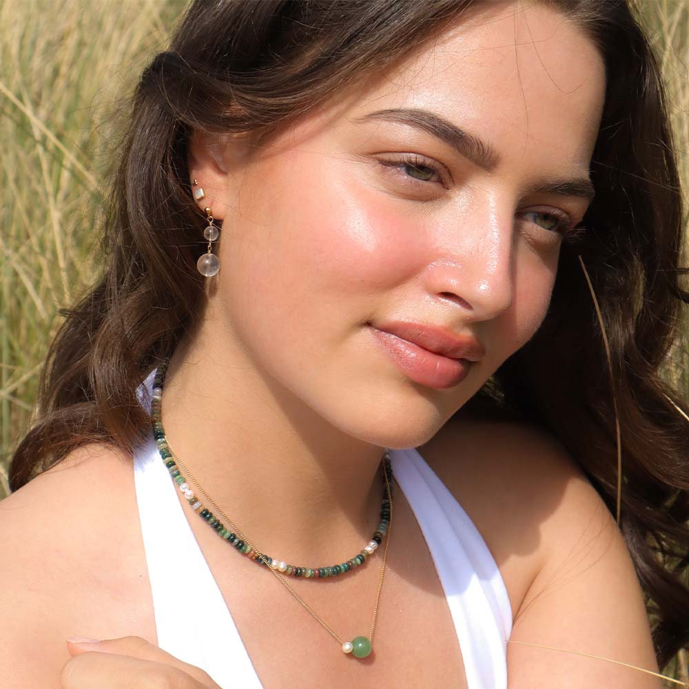 Woman with jewelry against a natural background
