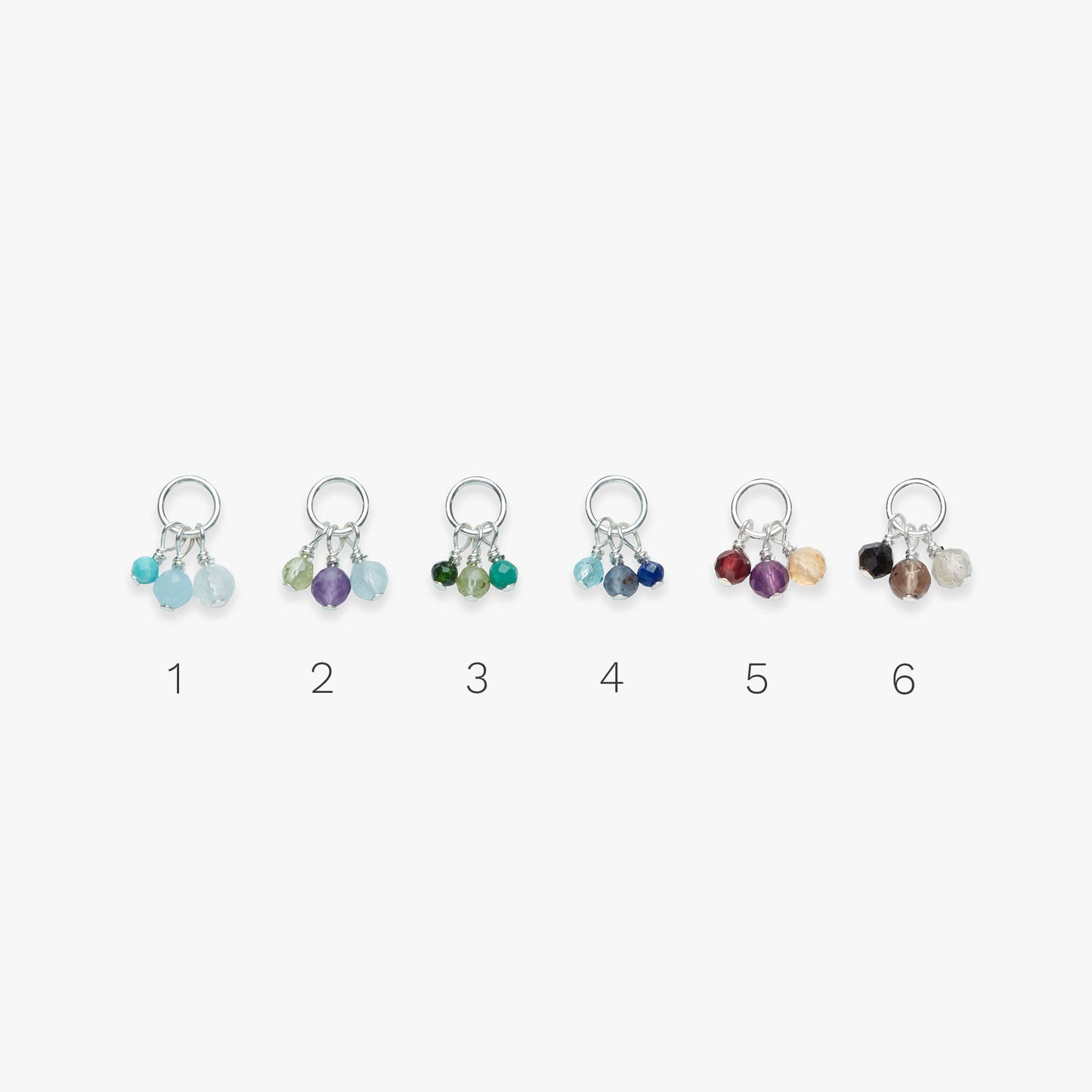 Set of six colorful stud earrings on a white background