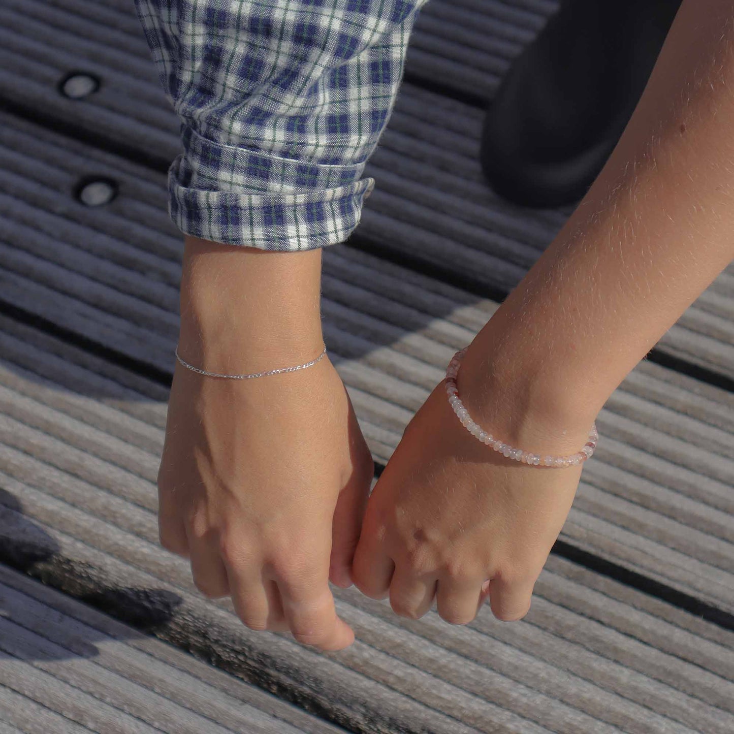 Two hands holding each other on a textured surface