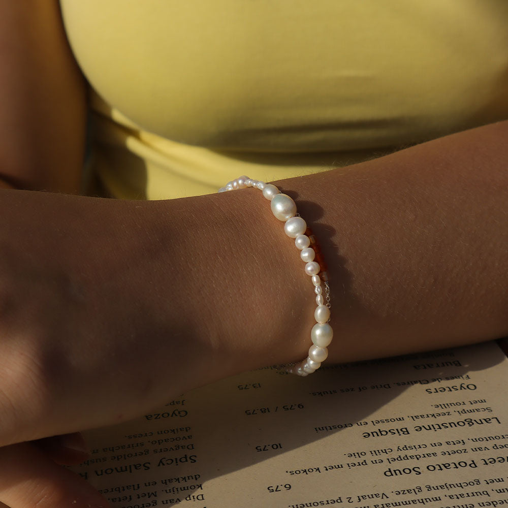 Pearl bracelet on a wrist with a blurred background