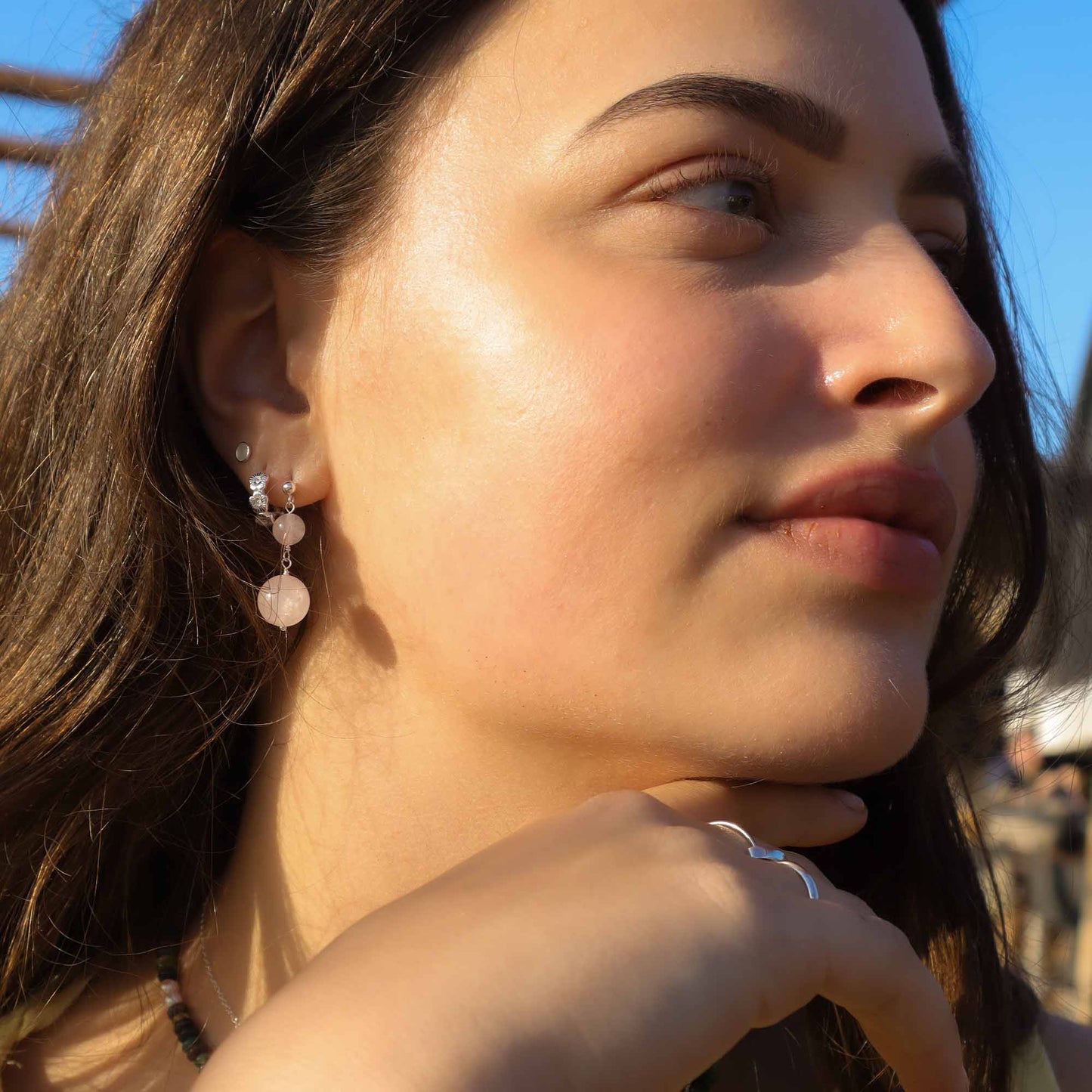 Close-up of a woman wearing earrings with a blurred background