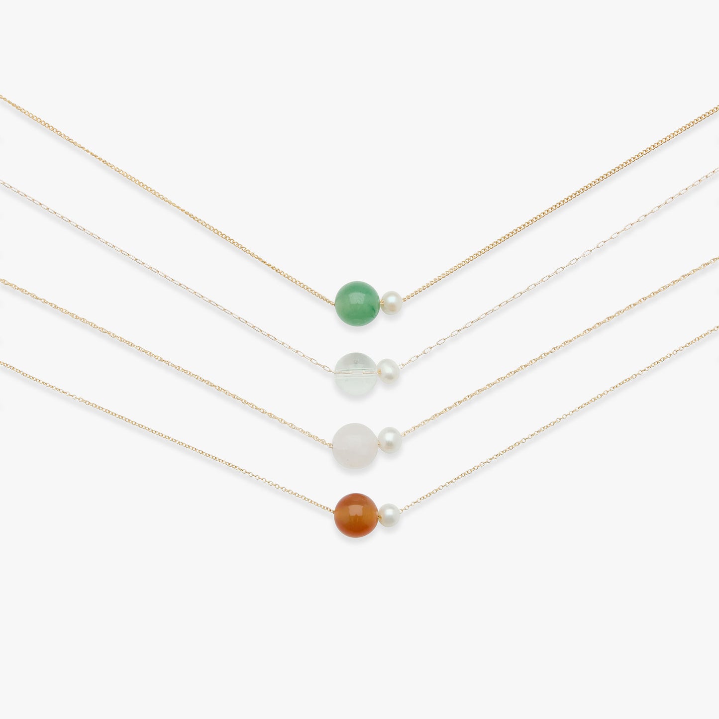 Set of four delicate necklaces with colored beads on a white background