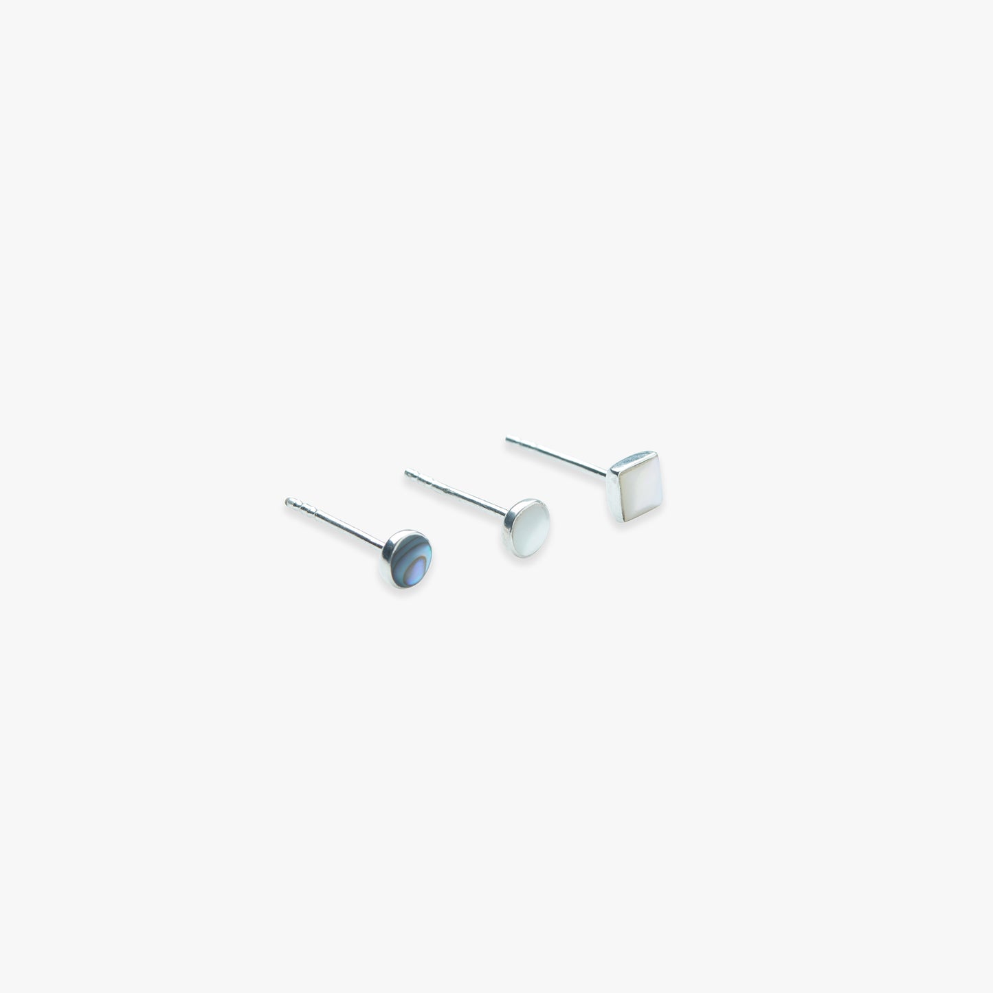 A pair of silver stud earrings featuring abalone and mother of pearl inlays, displayed against a white background.