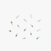 Colorful birthstone gemstone charms on a white background
