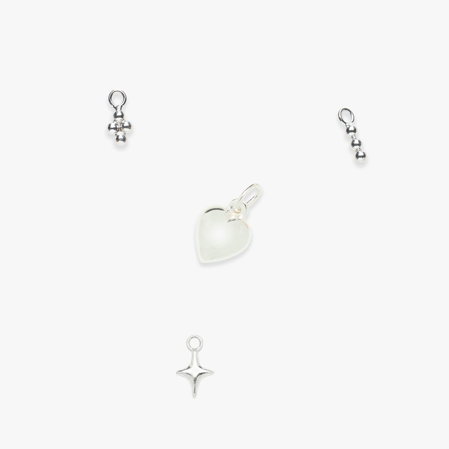 Set of silver charms on a white background