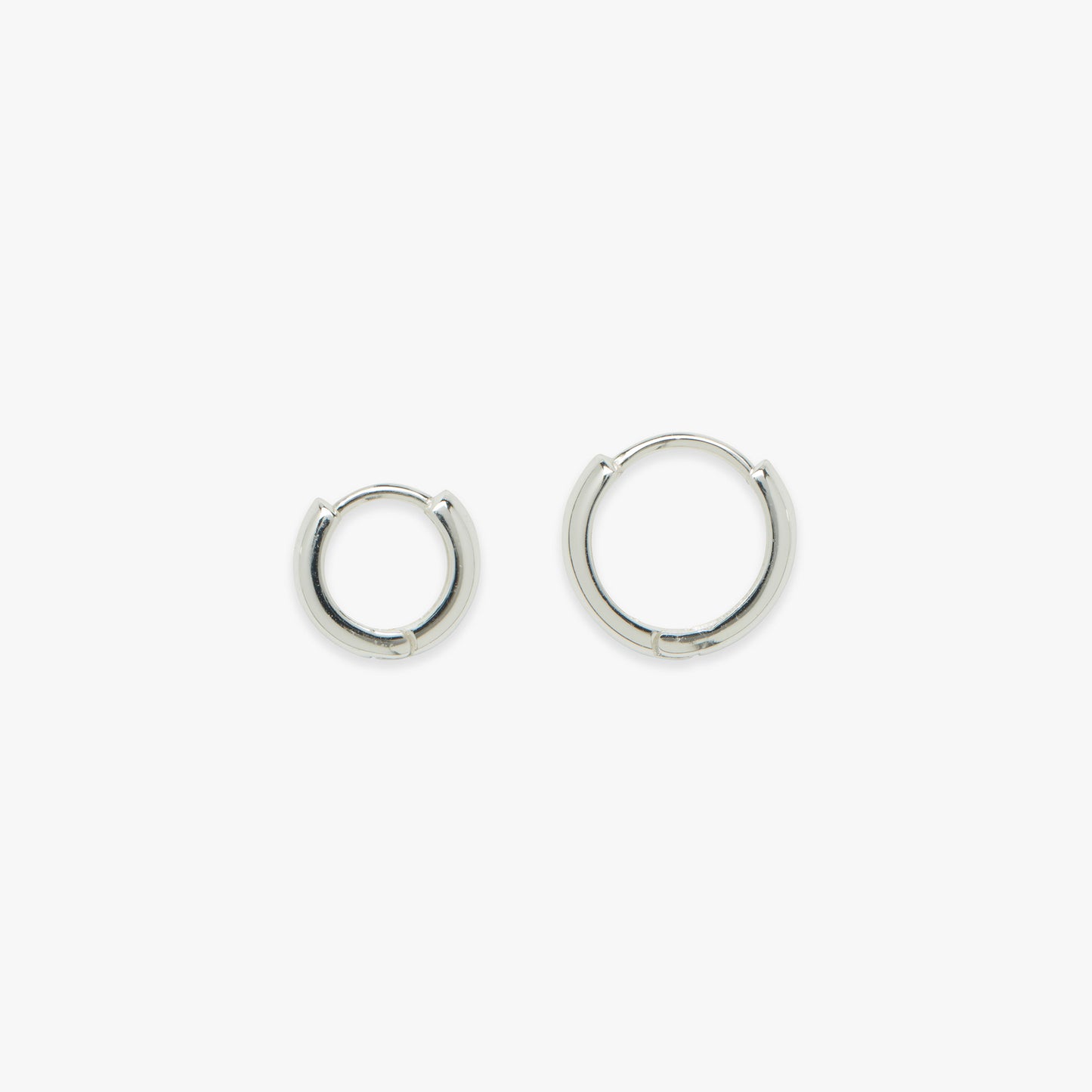 Small silver hoop earrings on a white background