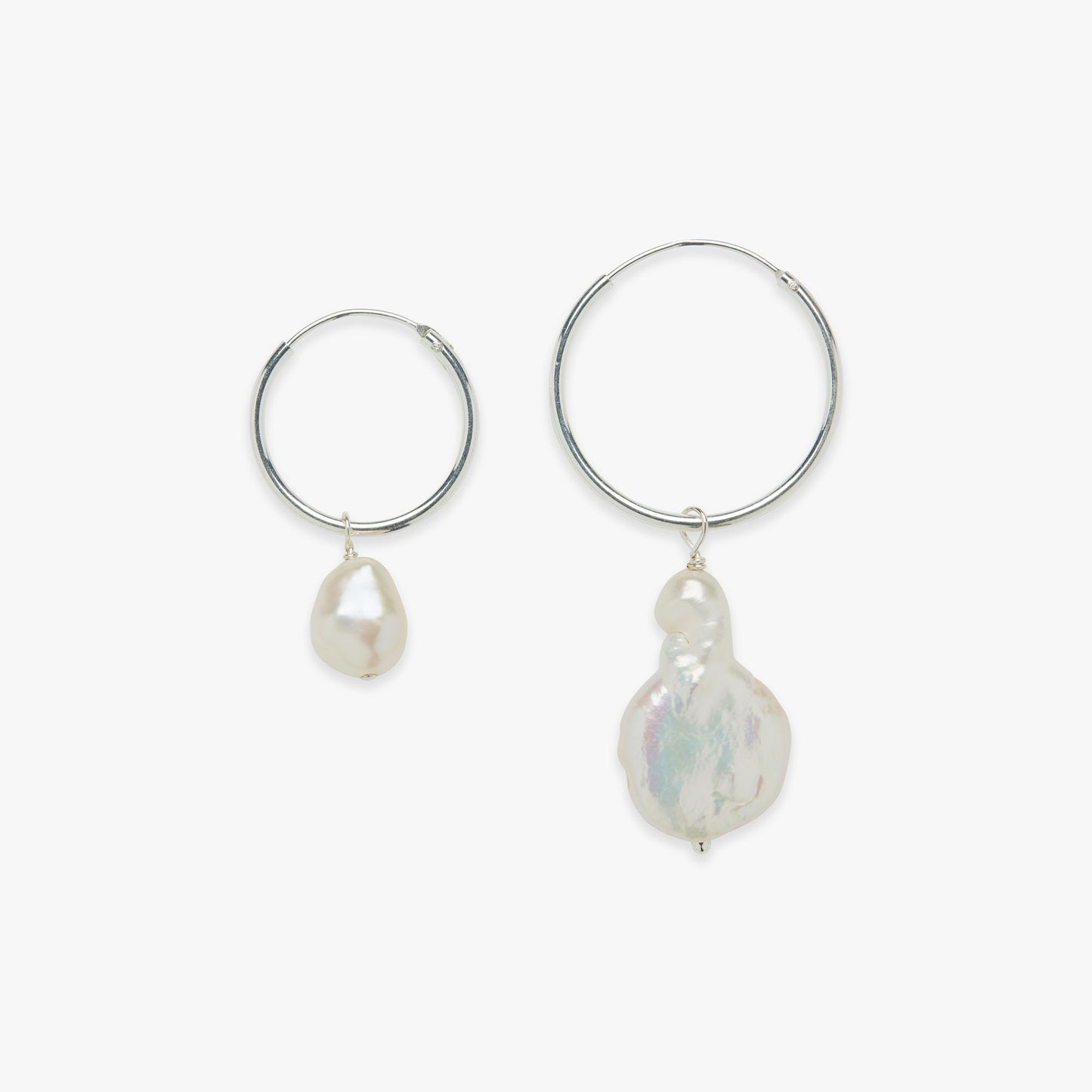 Pair of silver hoop earrings with pearl drops on a white background