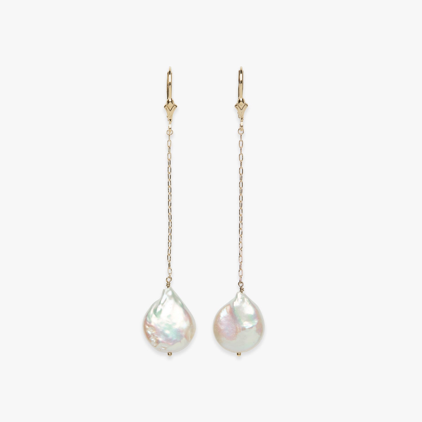 Pair of pearl earrings with gold chains on a white background