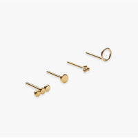 Set of gold stud earrings on a white background