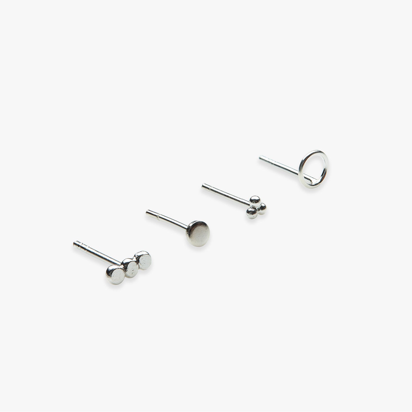 Set of silver stud earrings on a white background