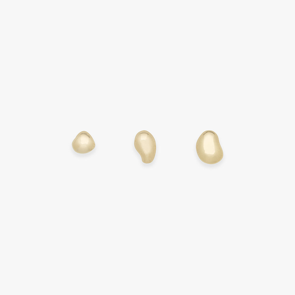 Three gold earrings on a white background