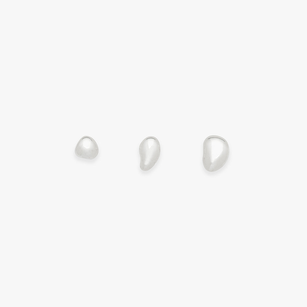 Set of three pearl earrings on a white background