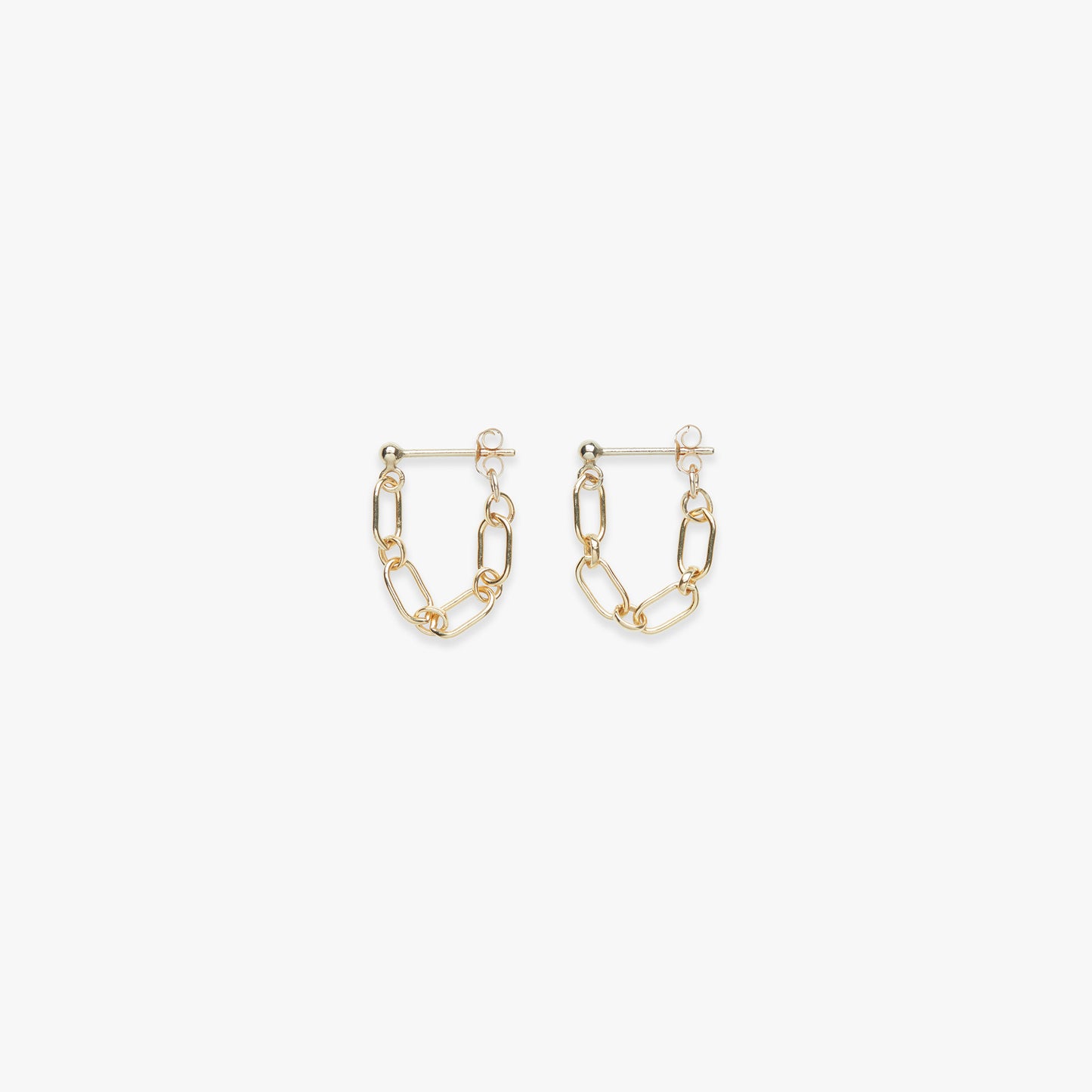 Gold chain link earrings on a white background