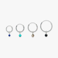 Set of four hoop earrings with colored gemstones on a white background