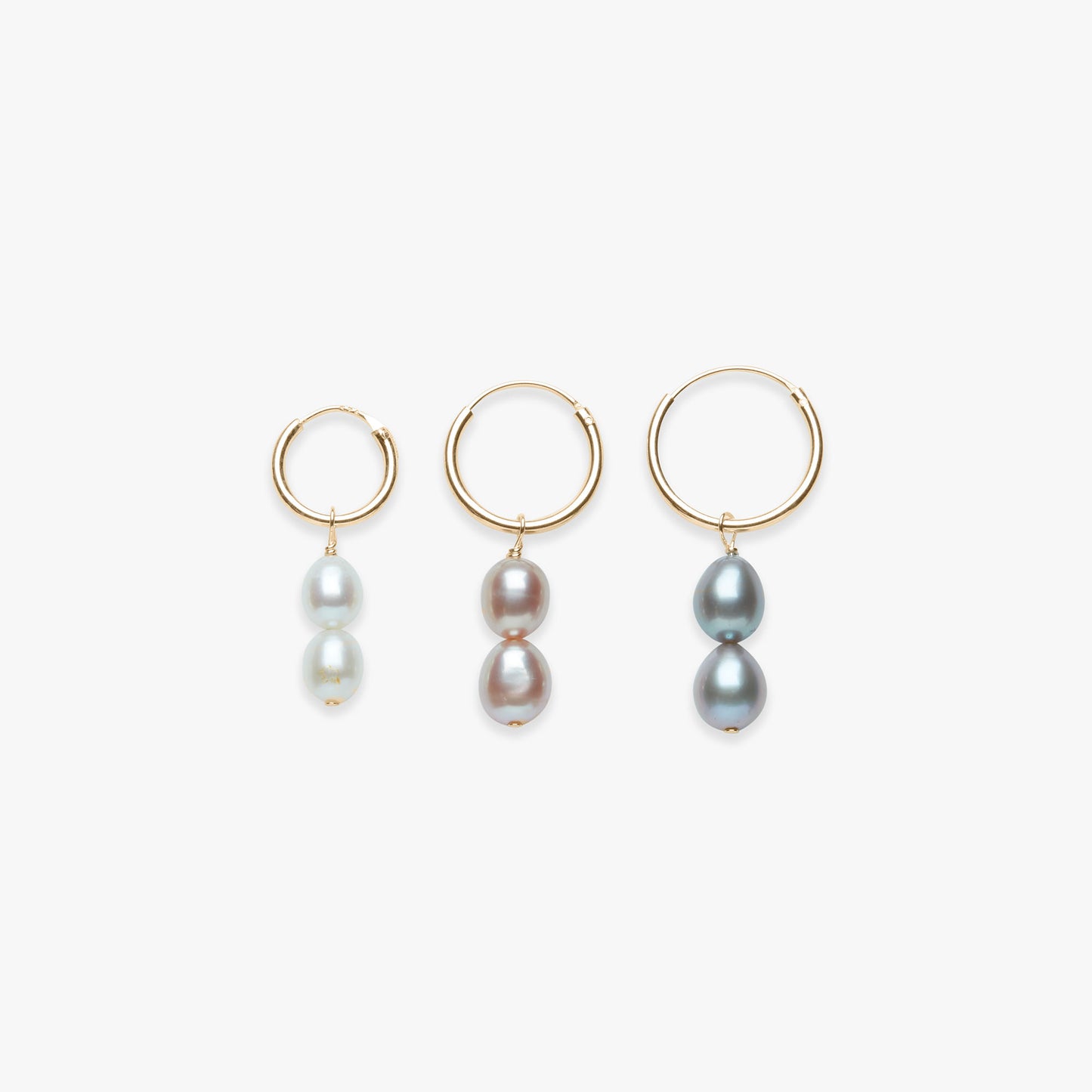 Three pairs of hoop earrings with pearls on a white background