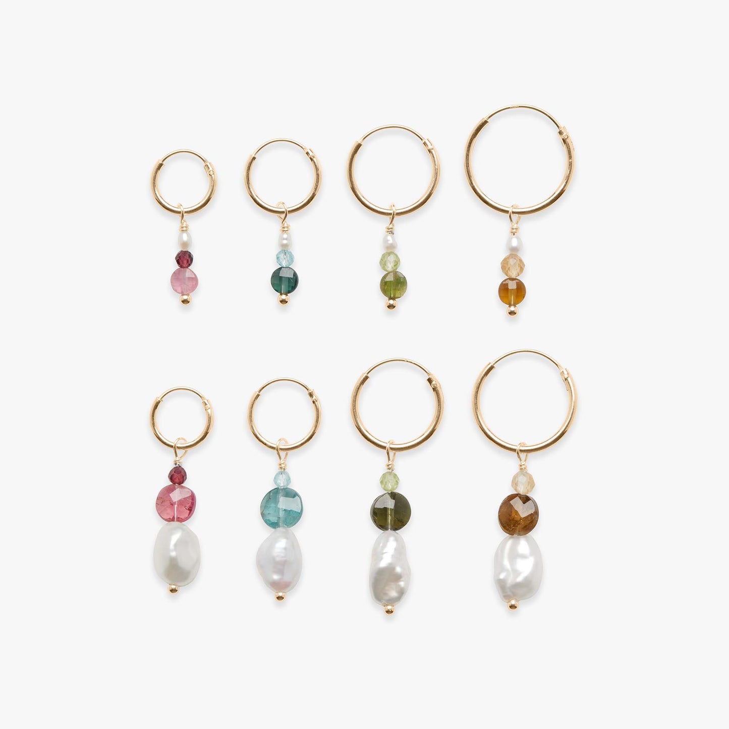 Set of gold hoop earrings with various colored beads on a white background