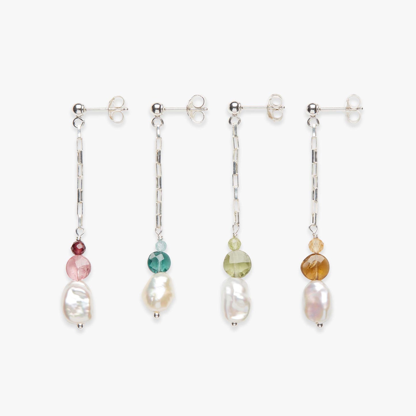 Set of four earrings with beads on a white background
