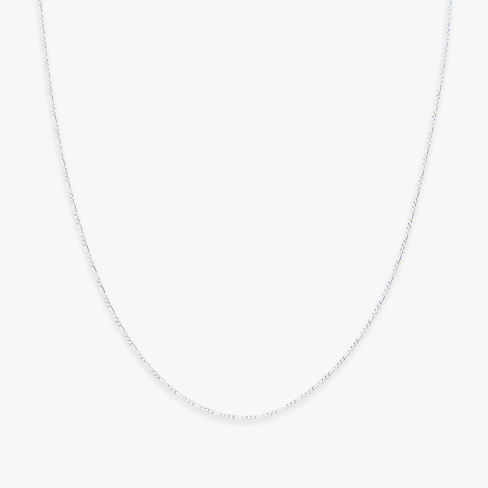 Silver chain necklace on a light gray background