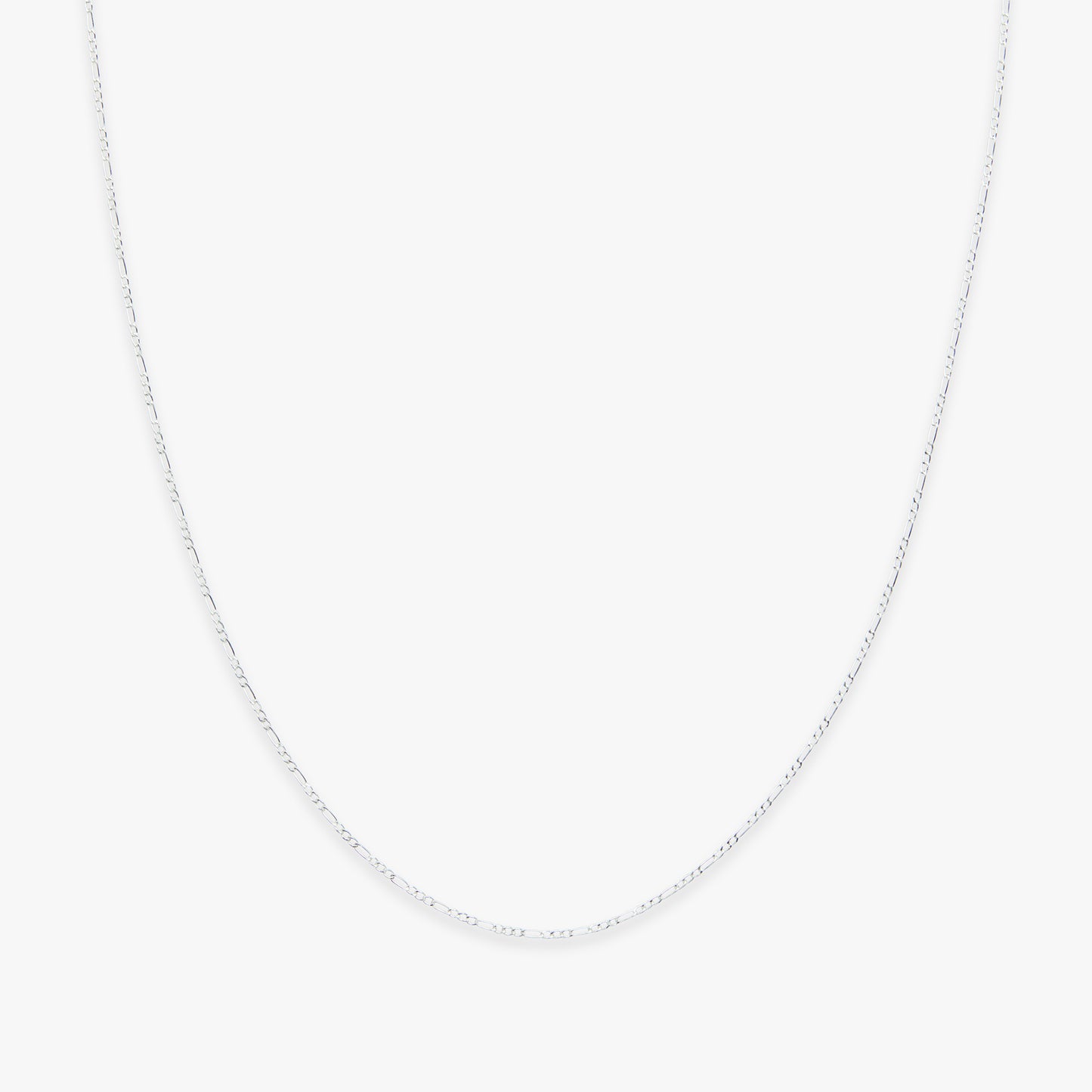 Silver chain necklace on a light gray background