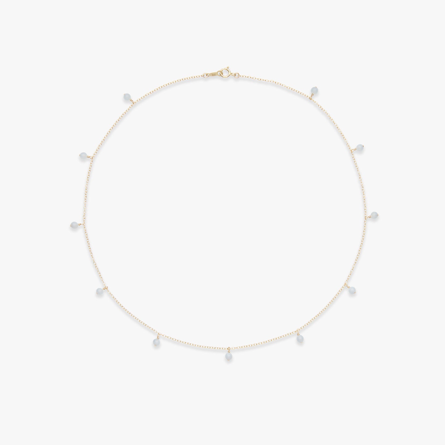 A delicate gold chain necklace with small, irregular white pearl-like beads spaced along the chain, displayed on a clean white background.