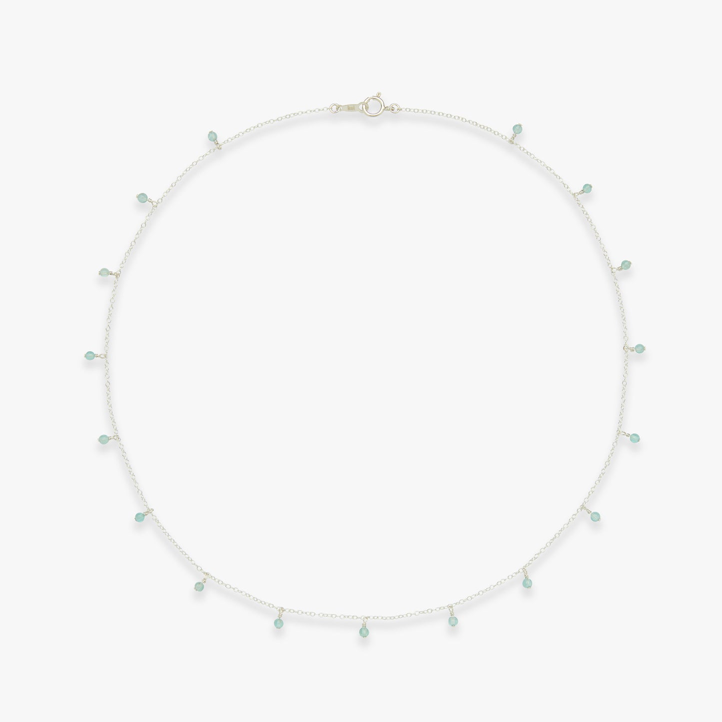 Necklace with small green beads on a white background