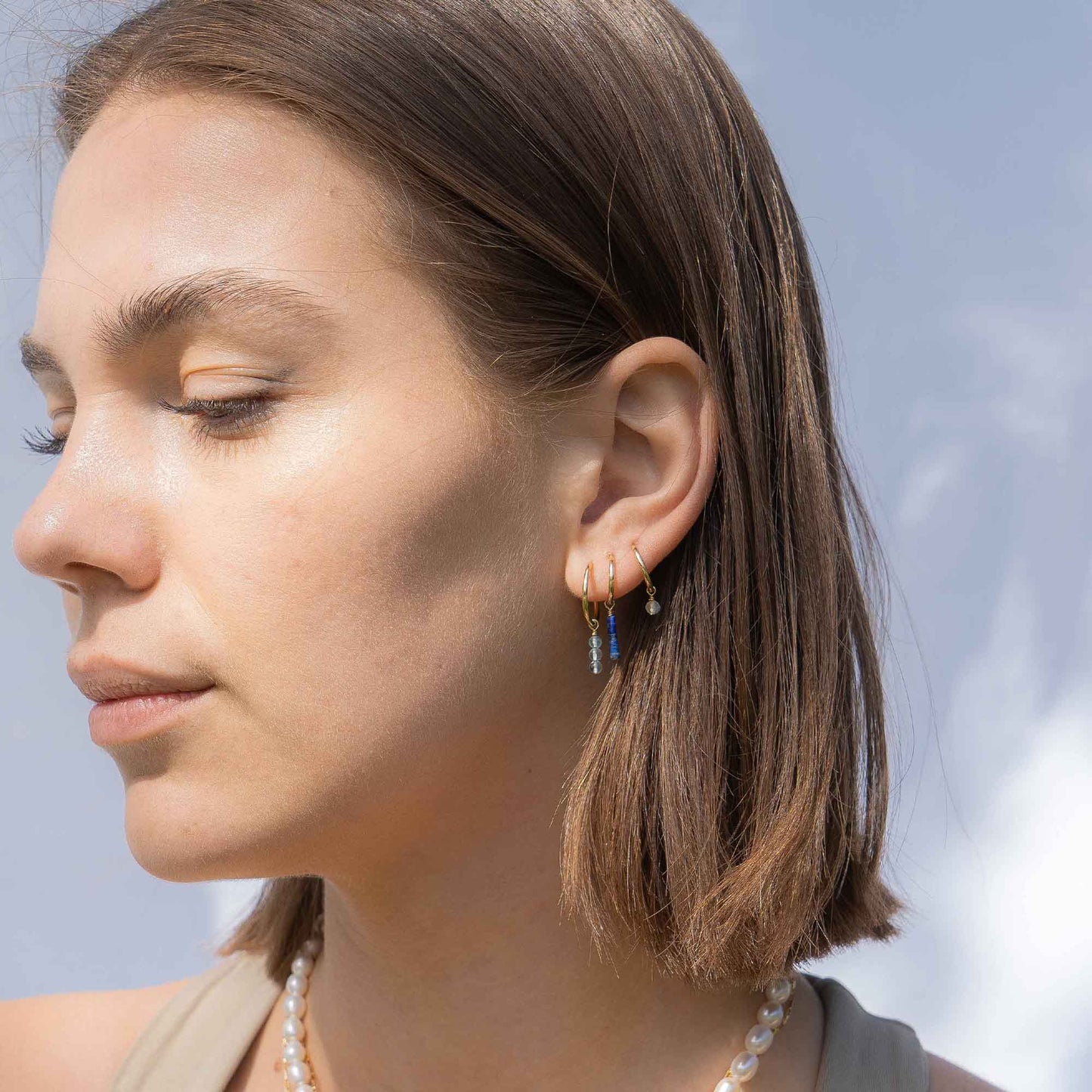 Close-up of a woman wearing earrings with a blurred background