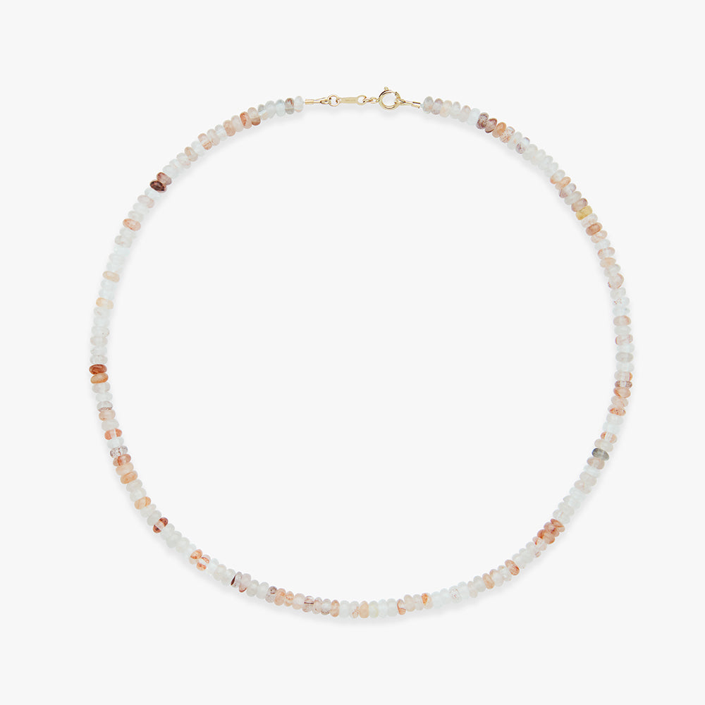 Beaded necklace with small stones on a white background