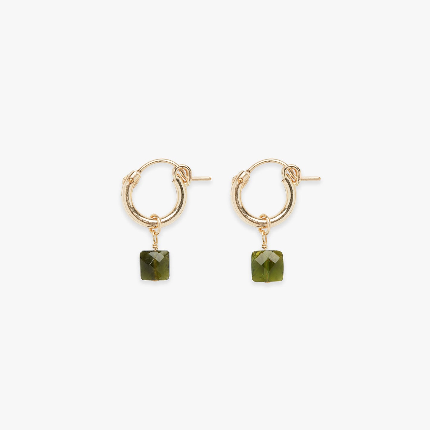 Gold hoop earrings with green square stones on a white background
