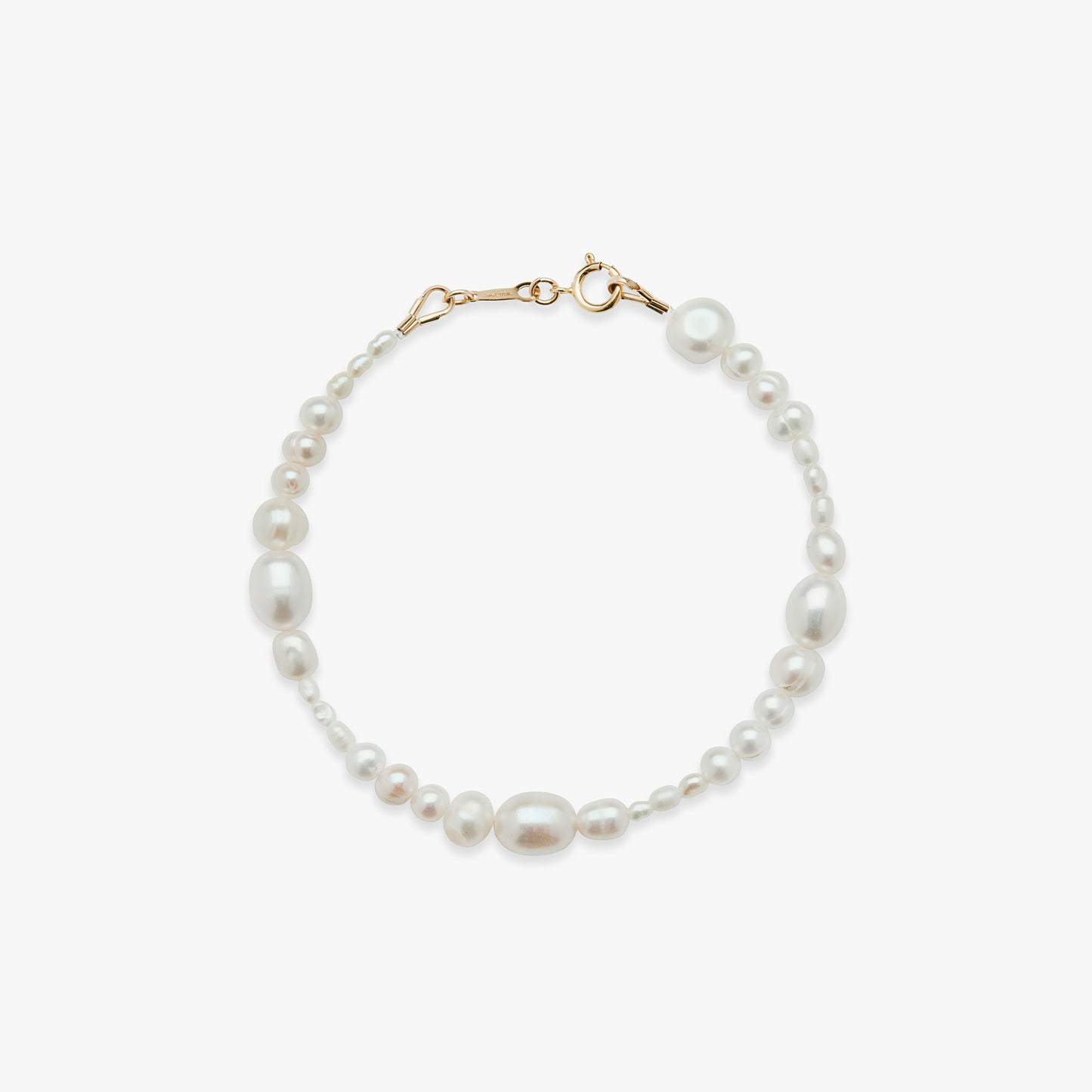 Pearl bracelet with gold clasp on a white background