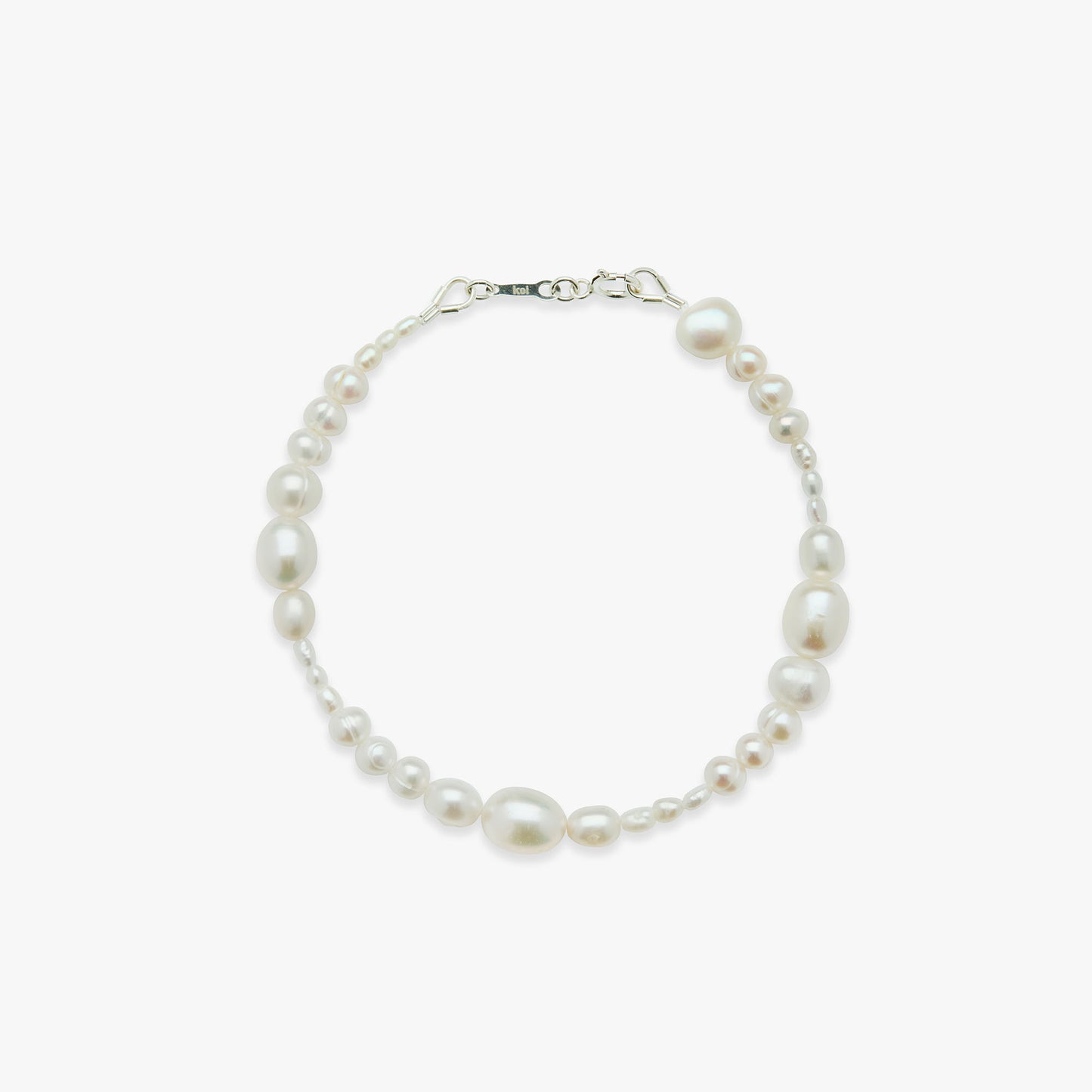 Pearl bracelet with silver clasp on a white background