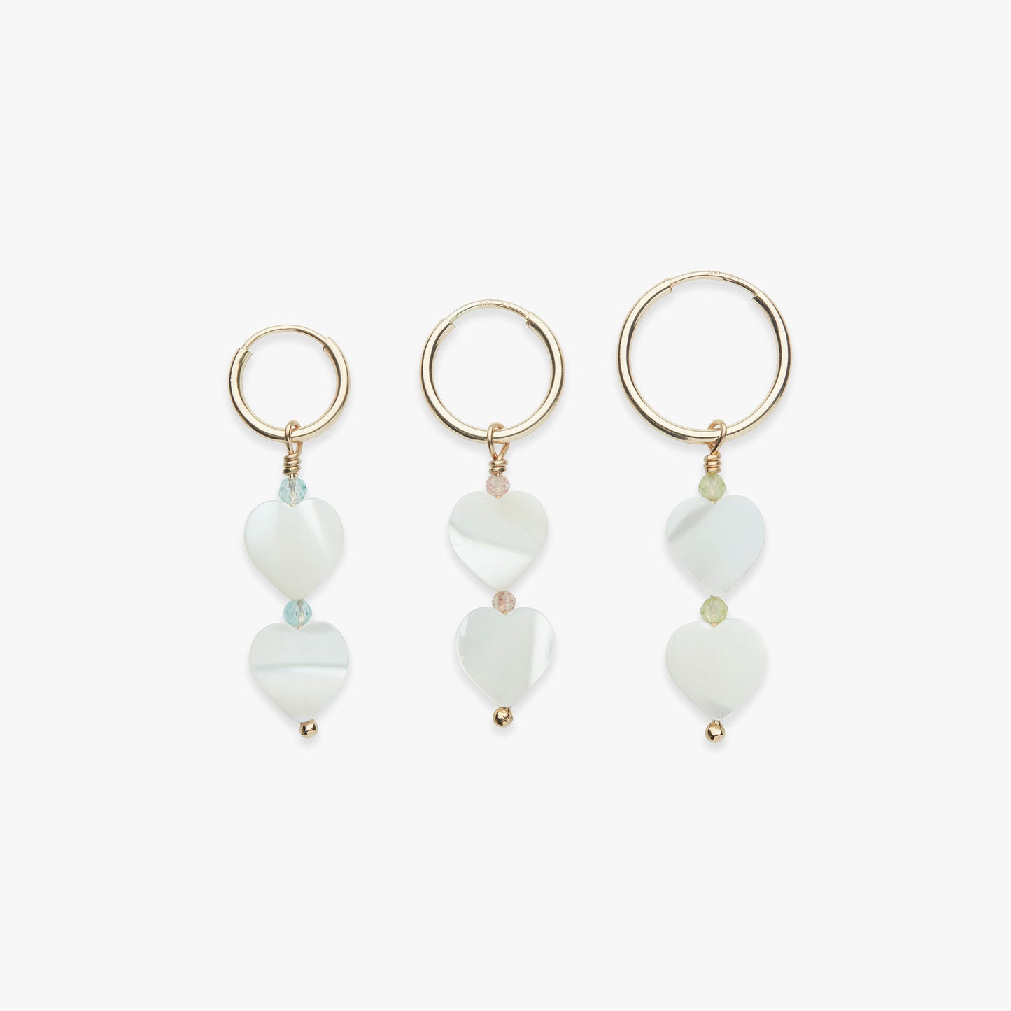 A set of three gold vermeil hoop earrings with heart-shaped mother of pearl and gemstone accents, inspired by the Powerpuff Girls.