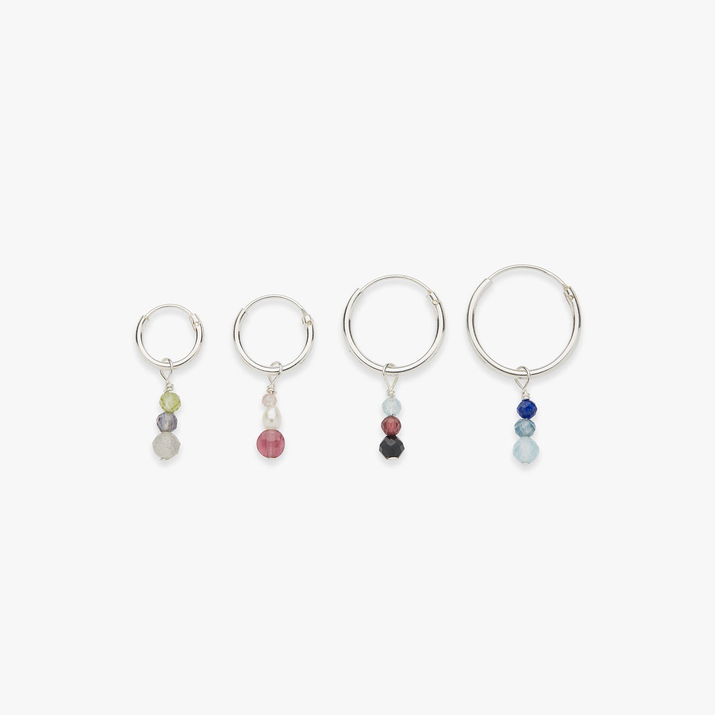 Set of four silver hoop earrings with colorful beads on a white background