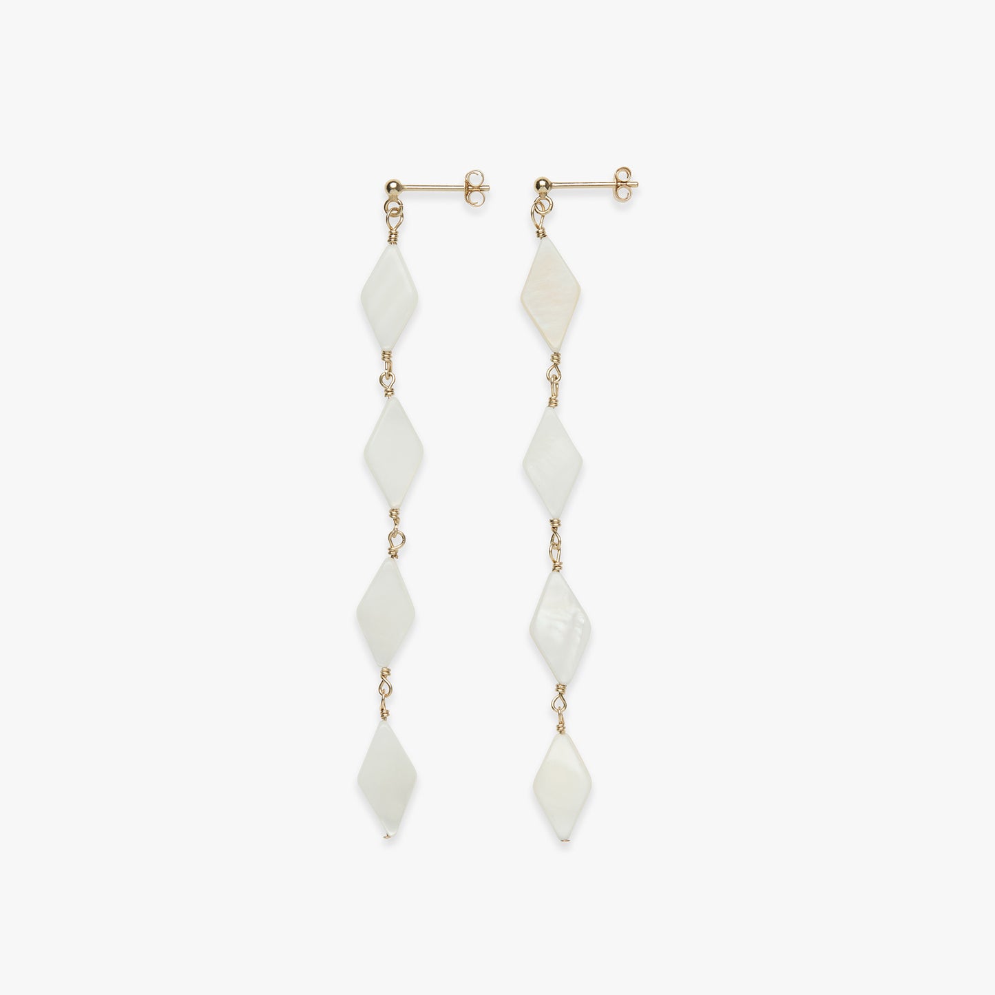 Pair of long earrings with white stones and gold accents on a white background