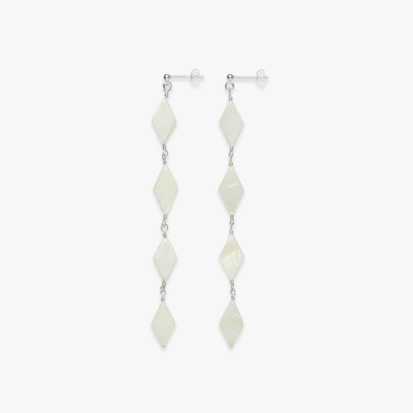 Pair of white diamond-shaped earrings on a white background