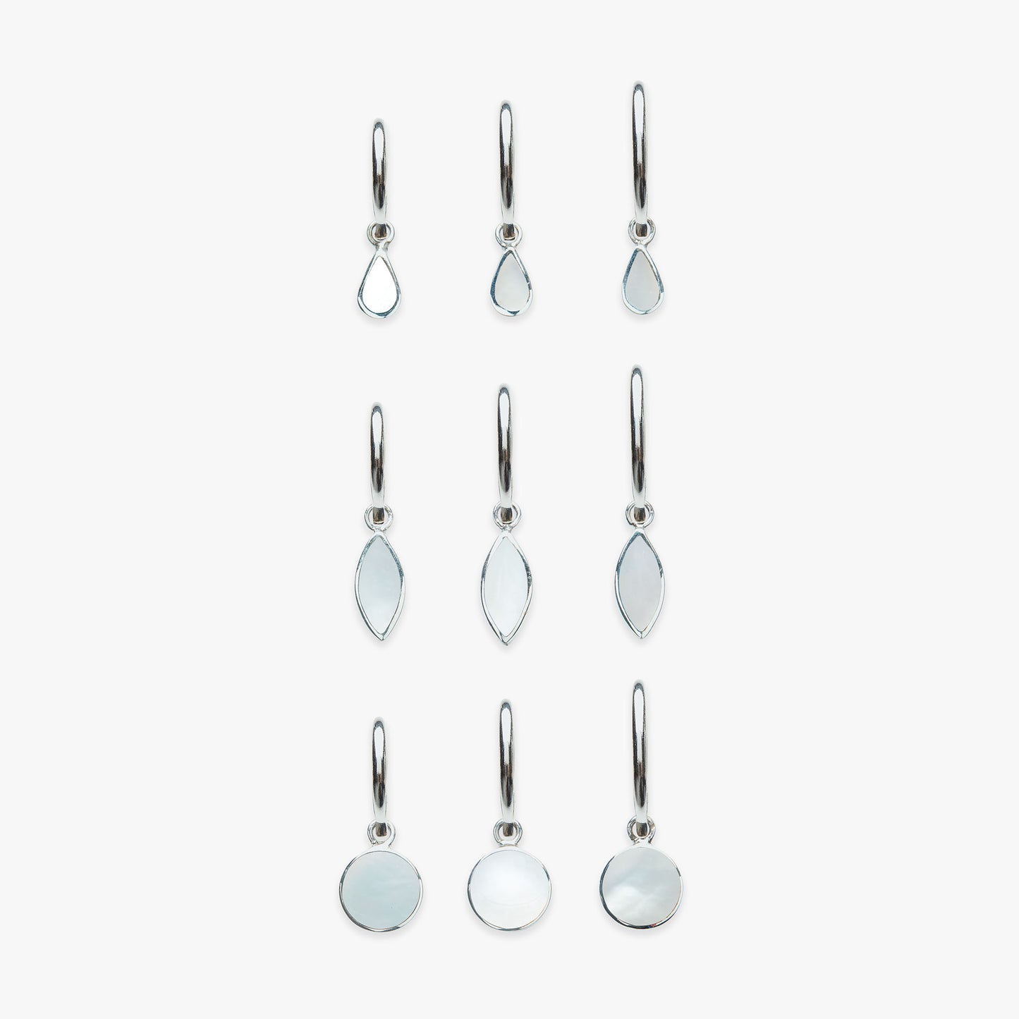 Set of silver earrings with mother of pearl gemstones on a white background