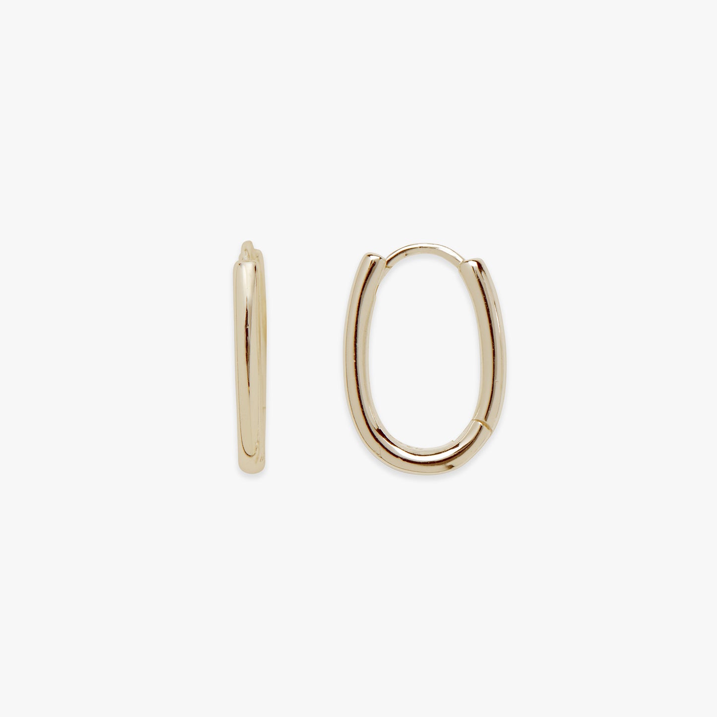 Gold oval hoop earrings on a white background