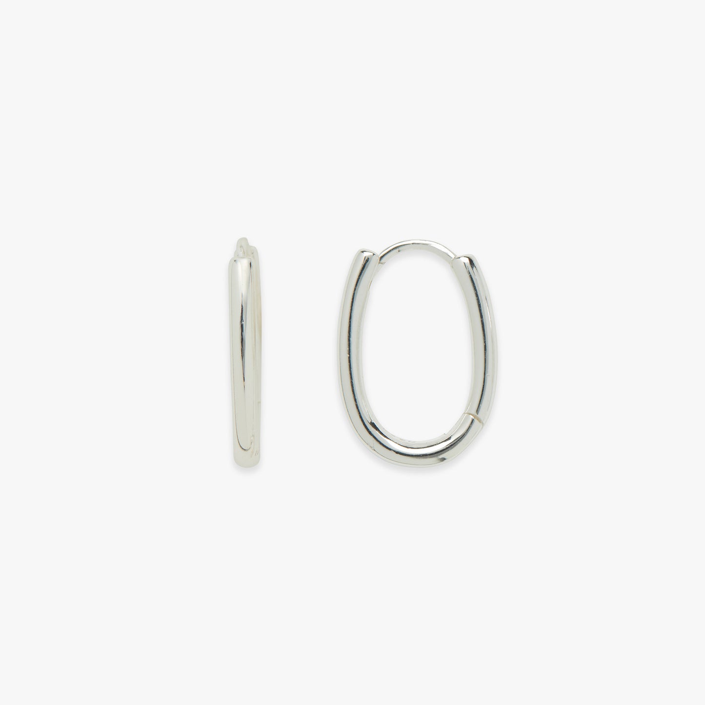 Pair of silver oval hoop earrings on a white background