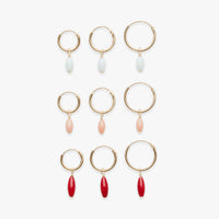 Set of gold hoop earrings with various colored beads on a white background