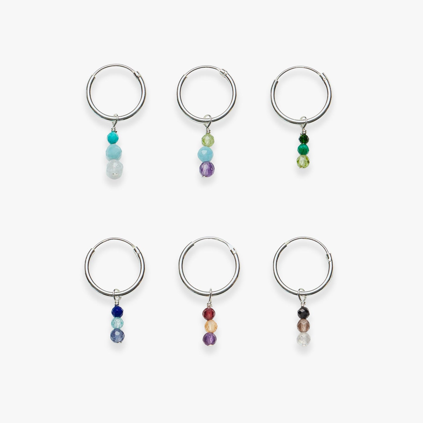 Set of six hoop earrings with colorful beads on a white background