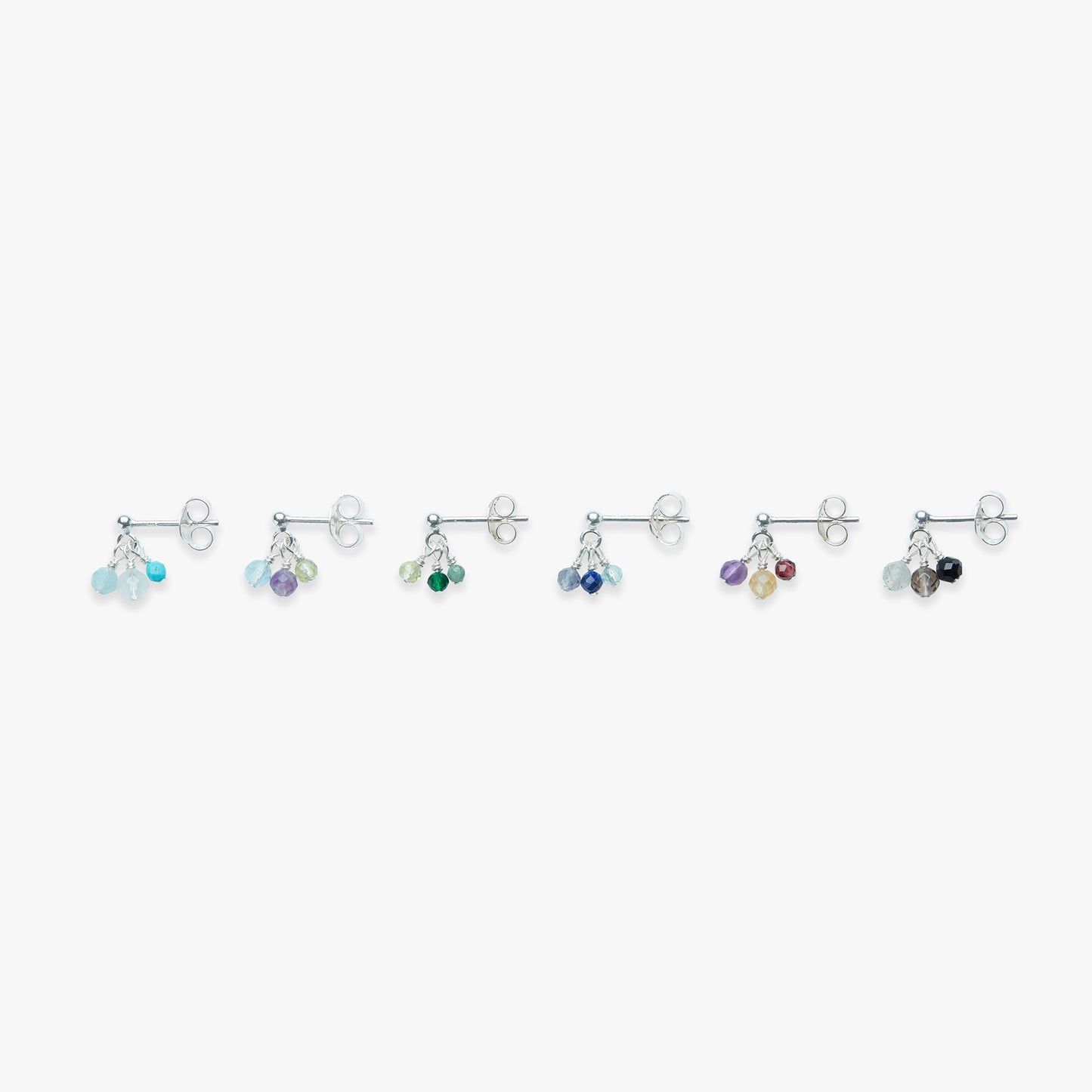 Set of silver earrings with colorful beads on a white background
