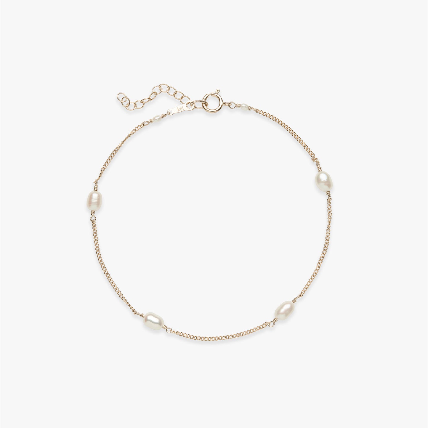 Gold anklet with pearls on a white background