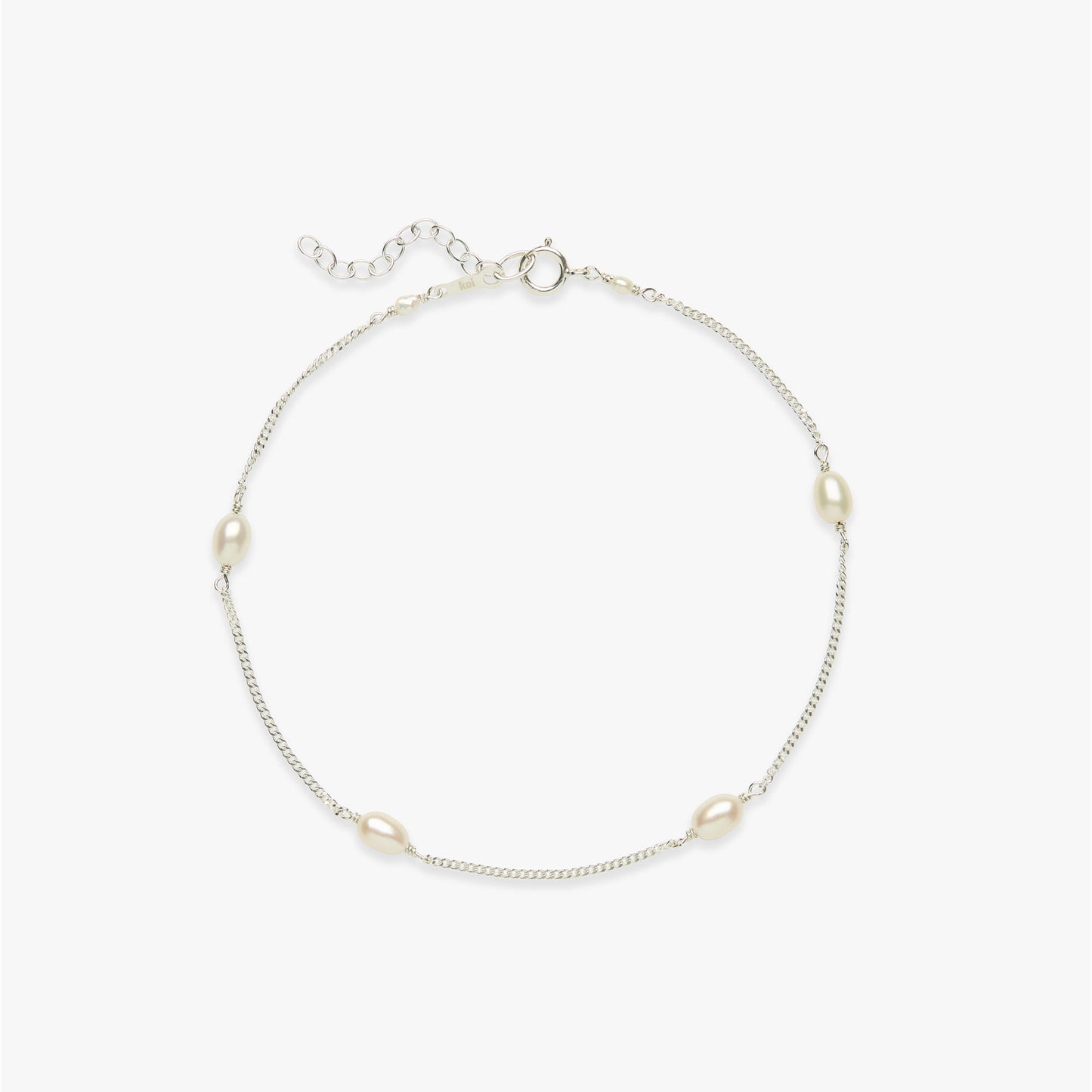 Silver anklet with pearls on a white background