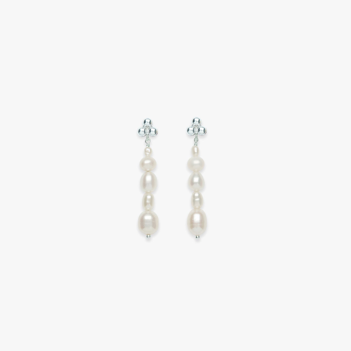 Pair of pearl earrings on a light gray background