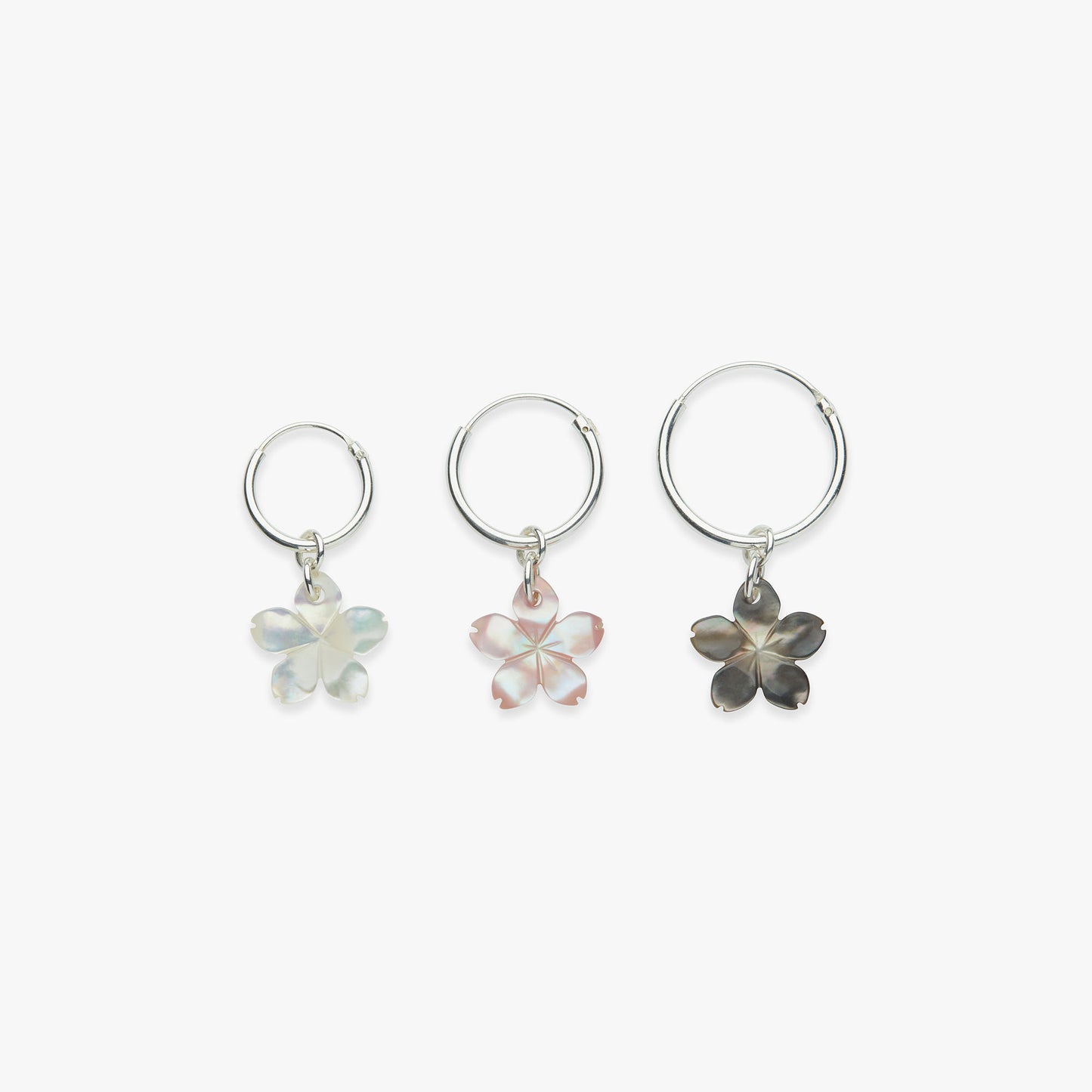 Three floral-shaped earrings on a white background