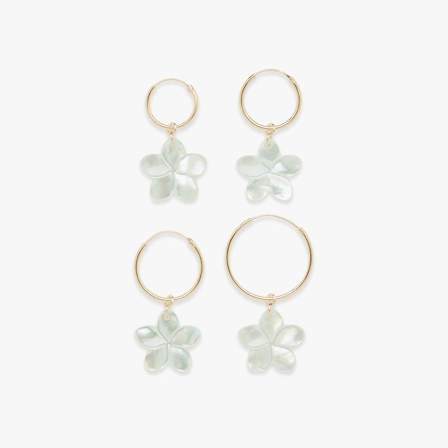 Set of four floral earrings on a white background