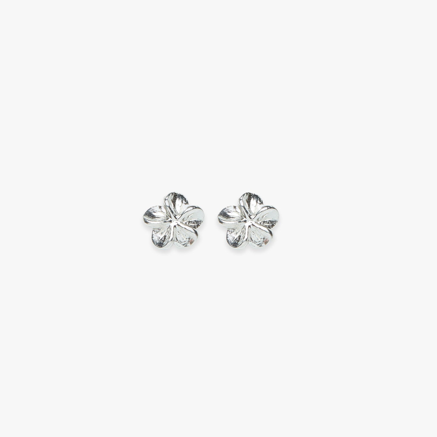 Silver tropical flower earrings on a white background