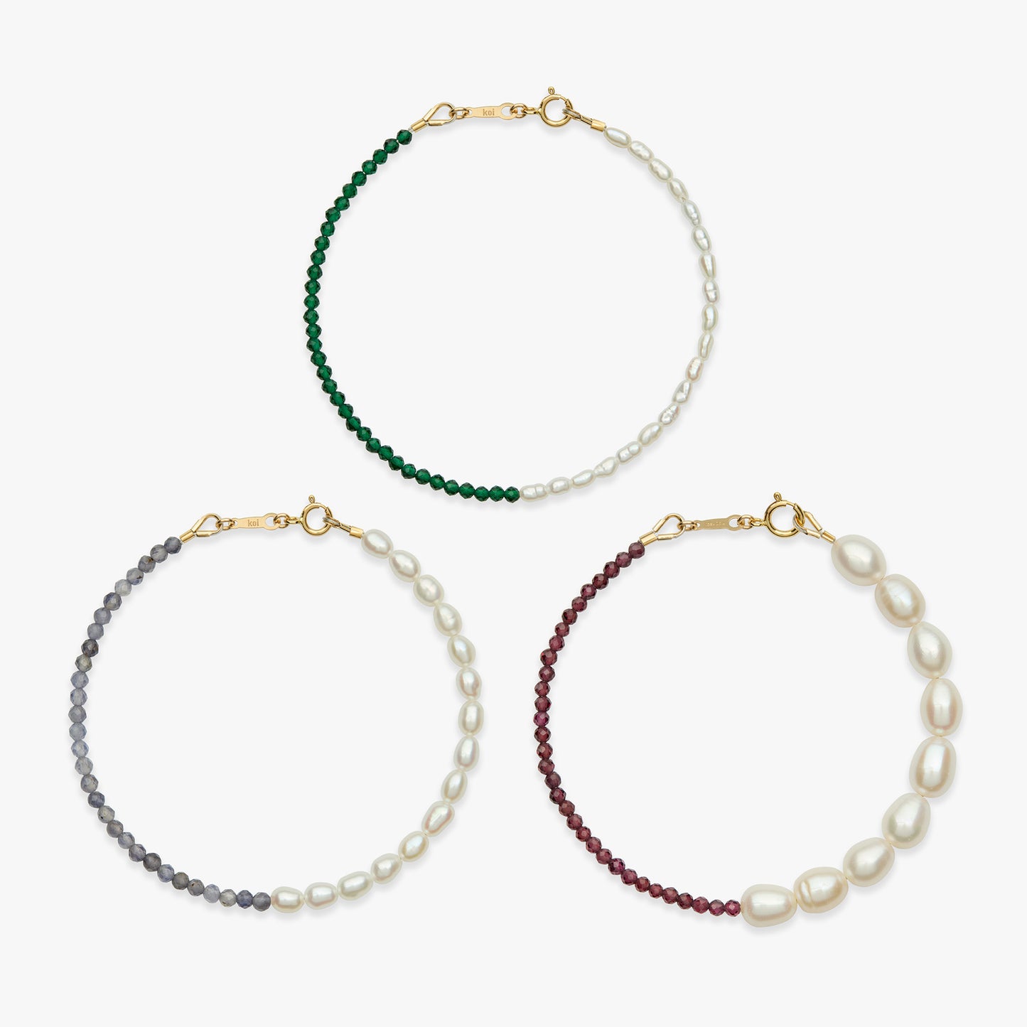 Three beaded bracelets with half pearl and half gemstone sections, displayed on a light gray background. The bracelets feature gold-tone clasps and are shown in green, gray, and burgundy colorways.